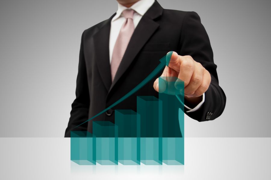 man creating a bar graph on glass