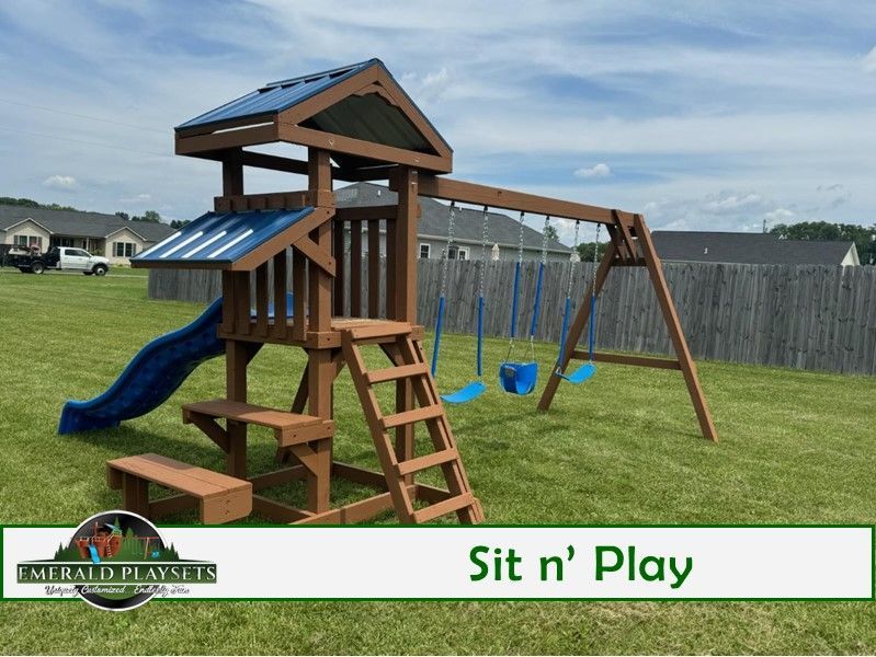 A playground set with a slide and swings in a backyard.