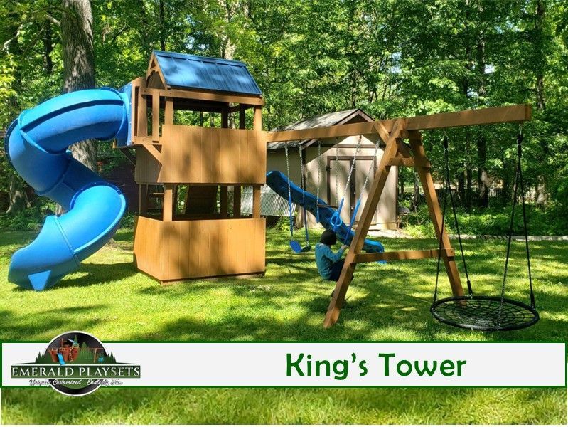 A wooden playground with a blue slide and swings.