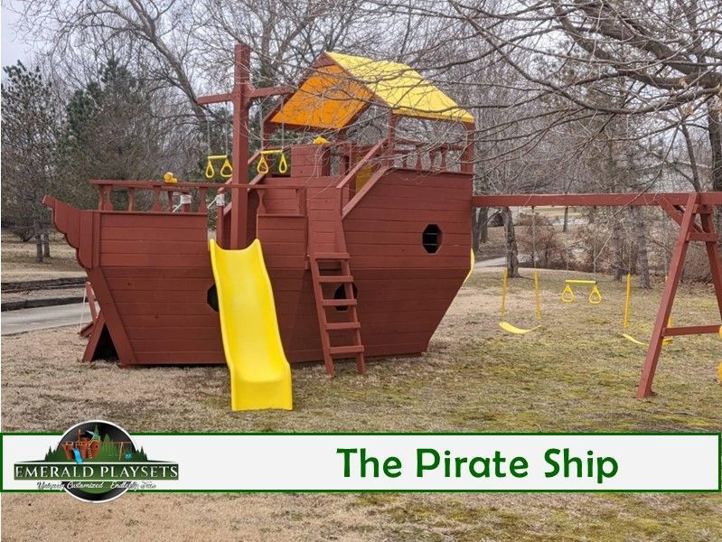 Wooden pirate ship playset with slide and swings. Brown structure, yellow slide, and orange roof.
