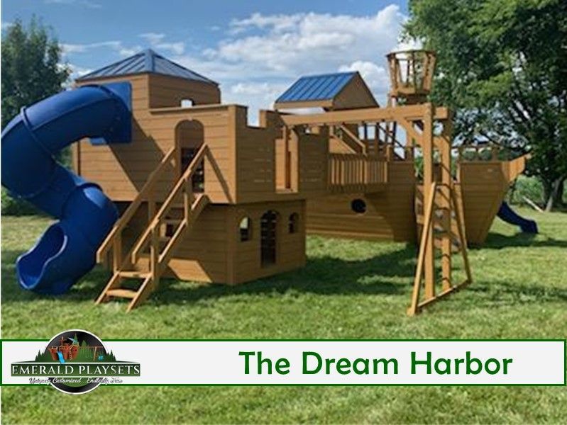 A large wooden playground set in the shape of a pirate ship