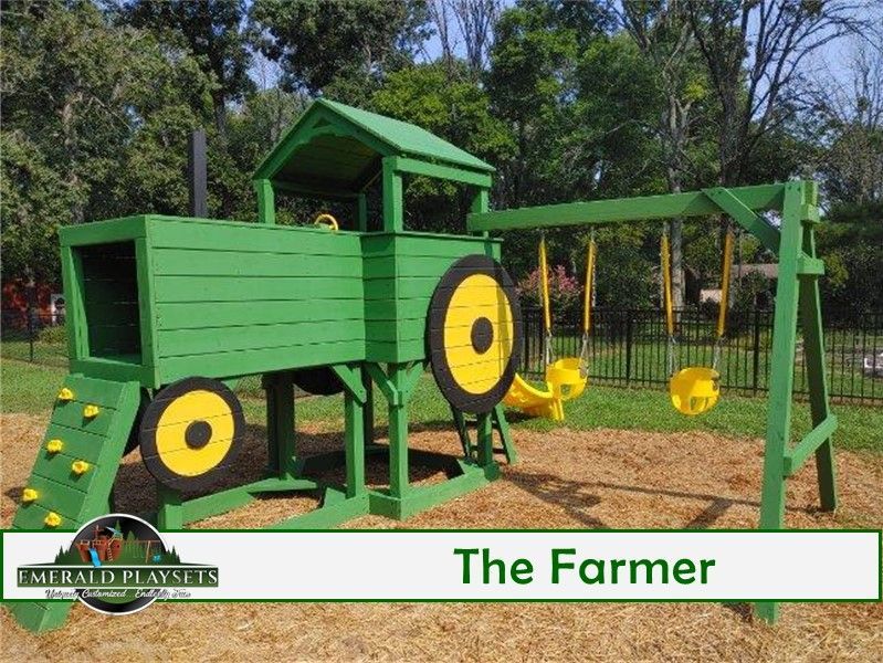 A green playground with yellow swings and a sign that says the farmer