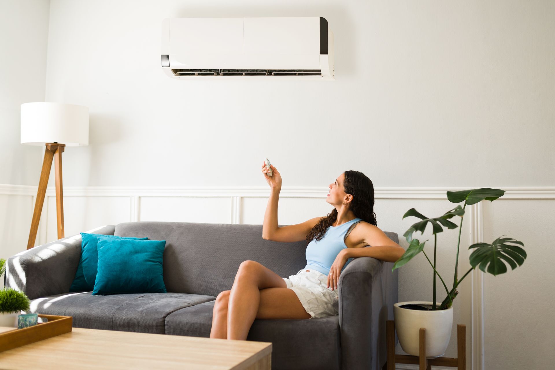 Happy woman enjoying her new air conditioning at home.