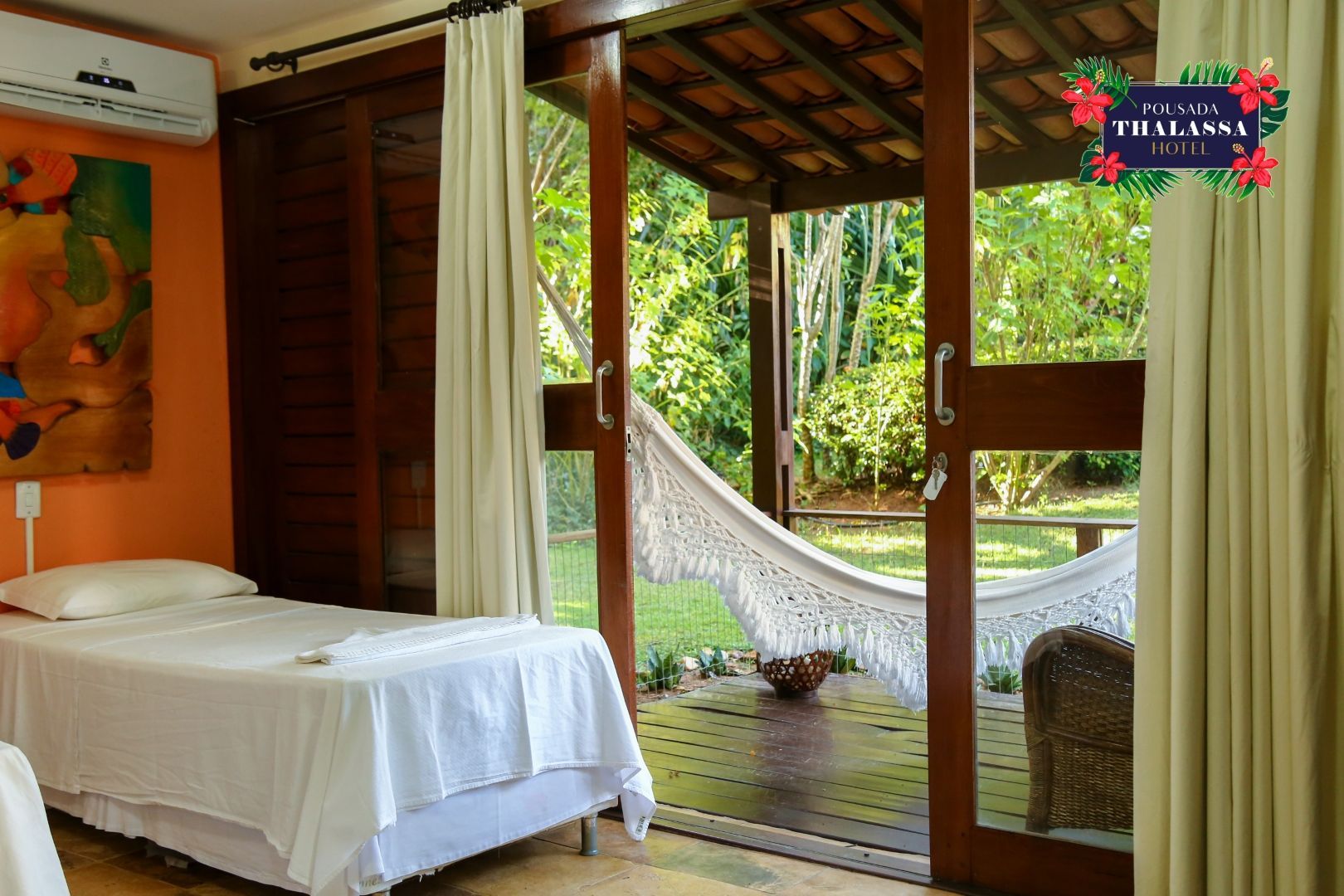 Um quarto com duas camas e uma rede