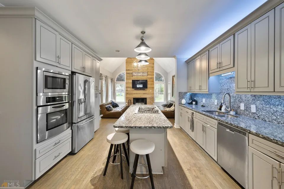 A kitchen with stainless steel appliances and granite counter tops.