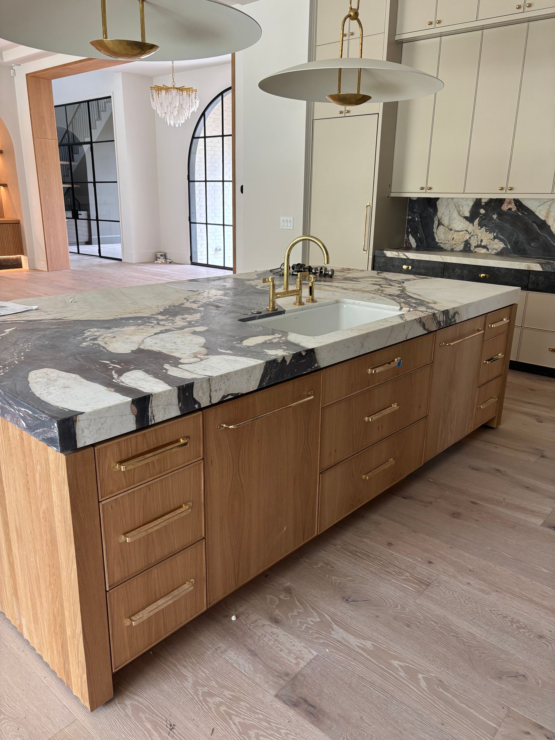 A kitchen with a large island and a sink.