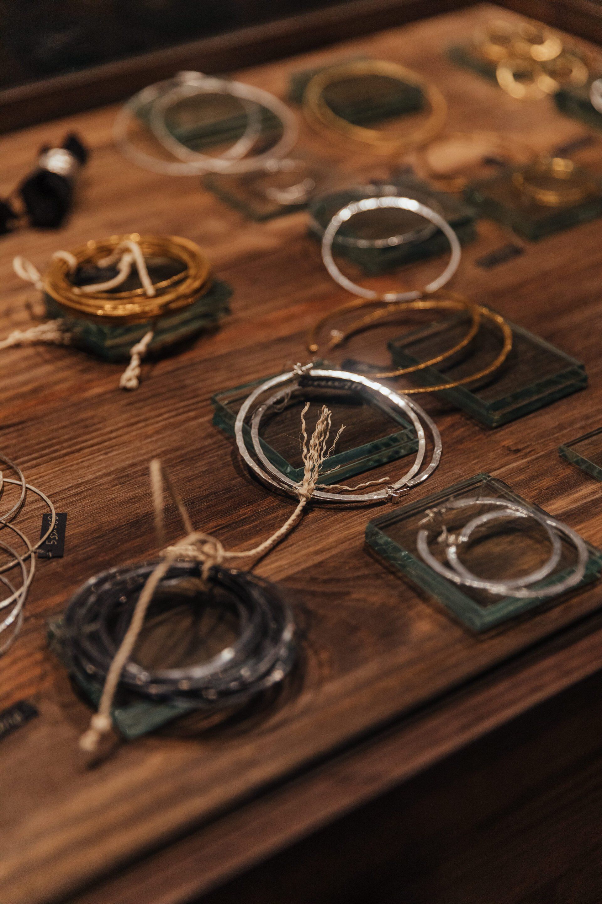 Una mesa de madera cubierta con una variedad de pulseras.
