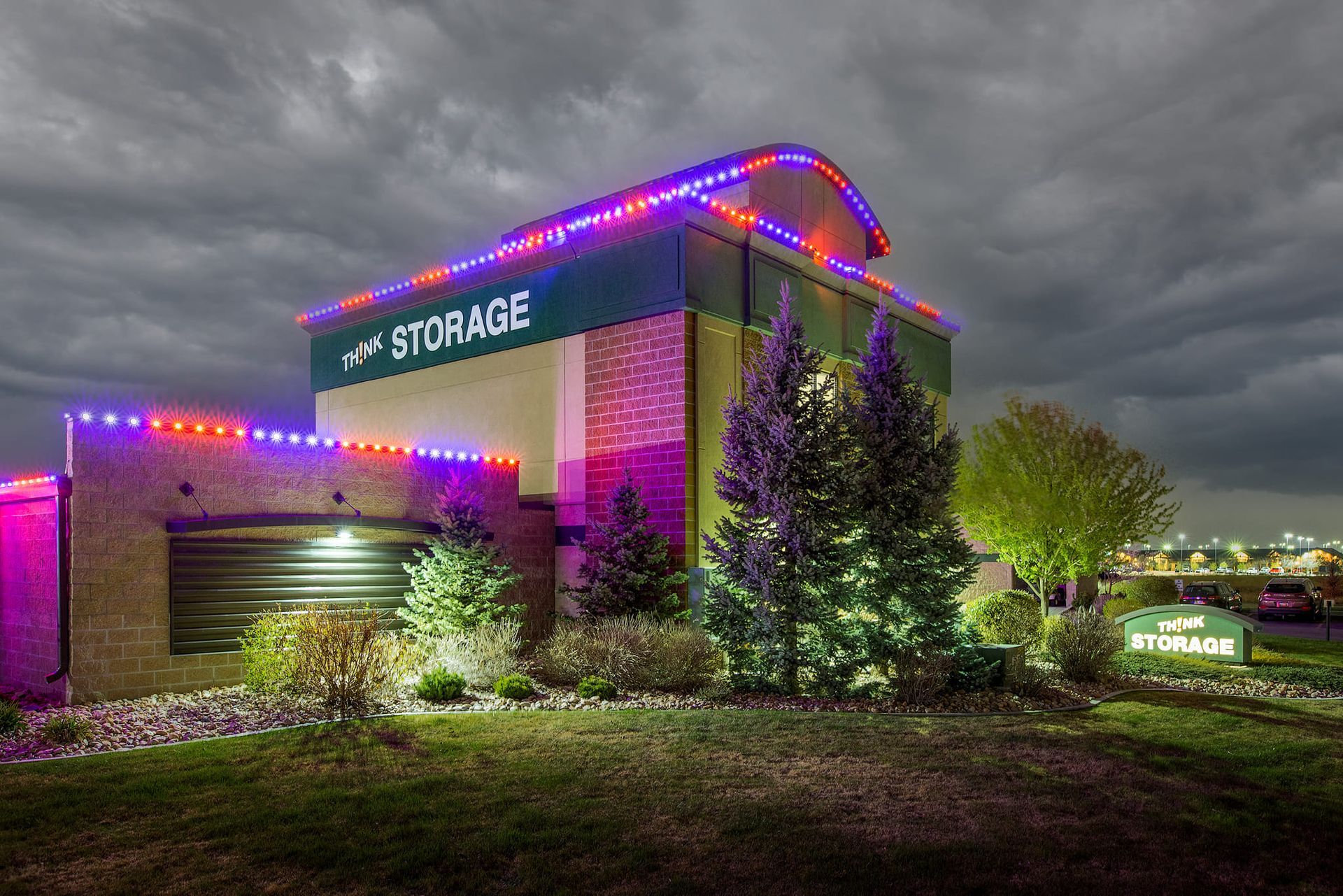 A storage building decorated with christmas lights at night.