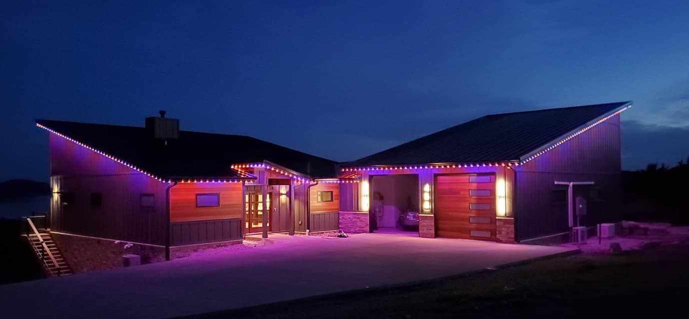 A house is lit up with purple lights at night.