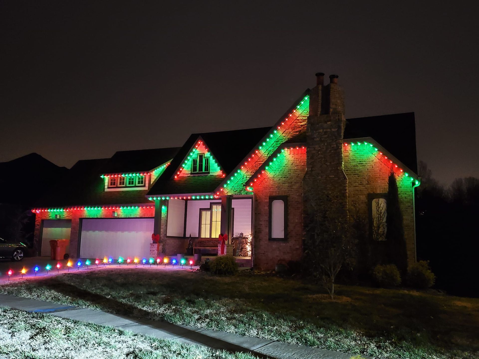 A house with christmas lights on it at night
