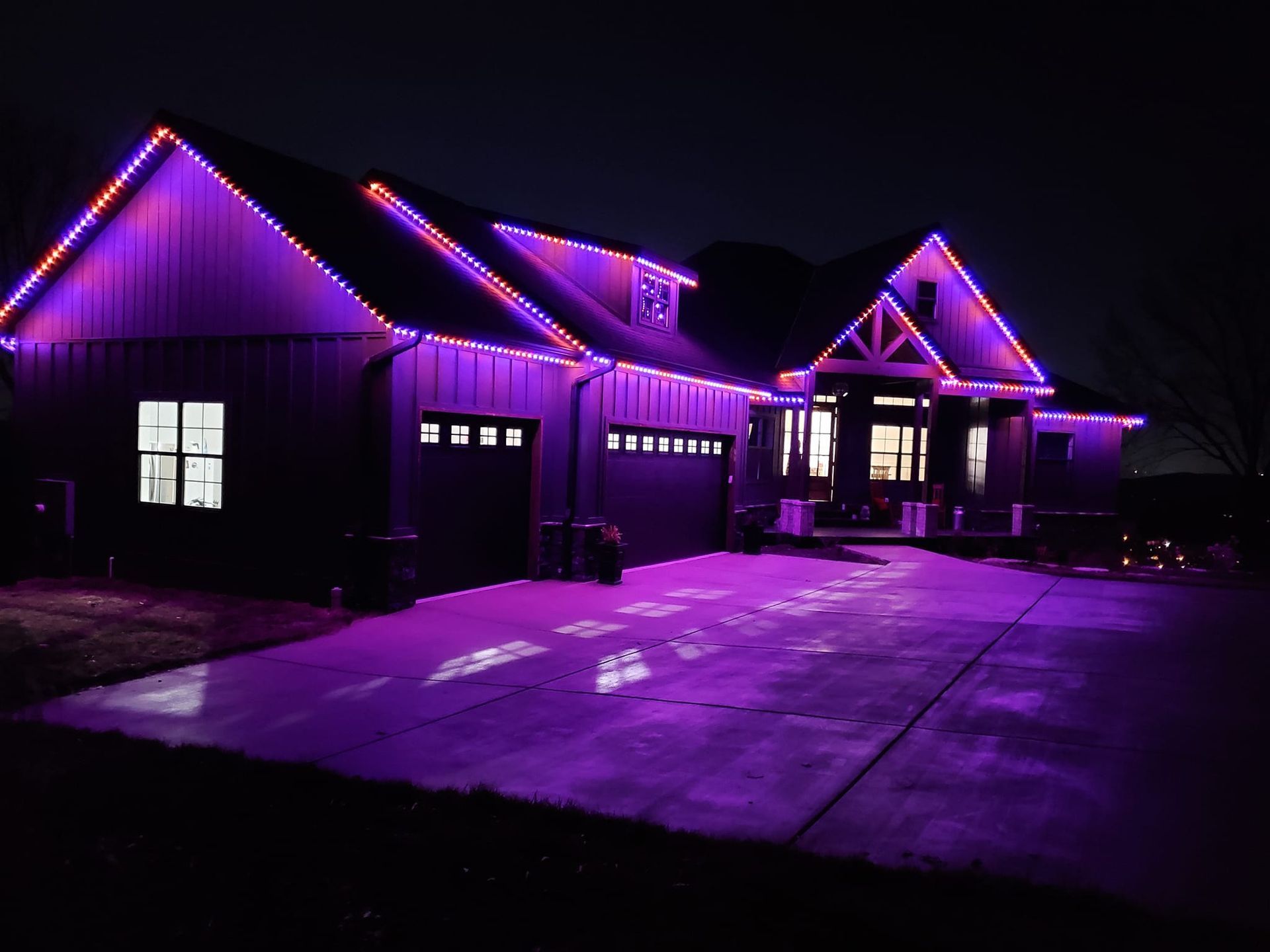 A house is lit up with purple lights at night.