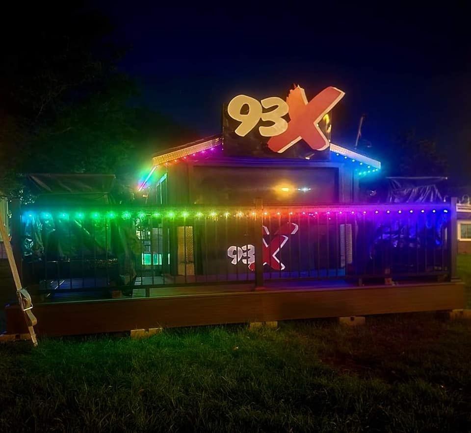 A house with a sign that says 93x on it