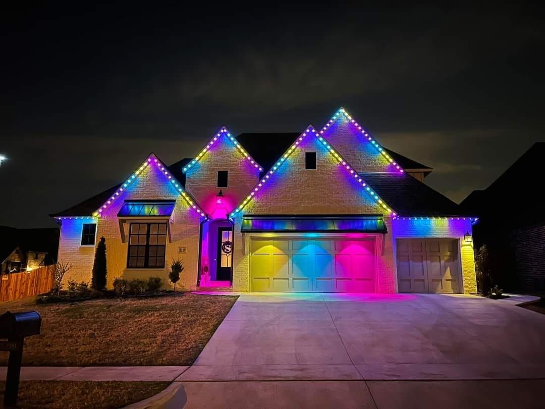 A house with christmas lights on it at night.