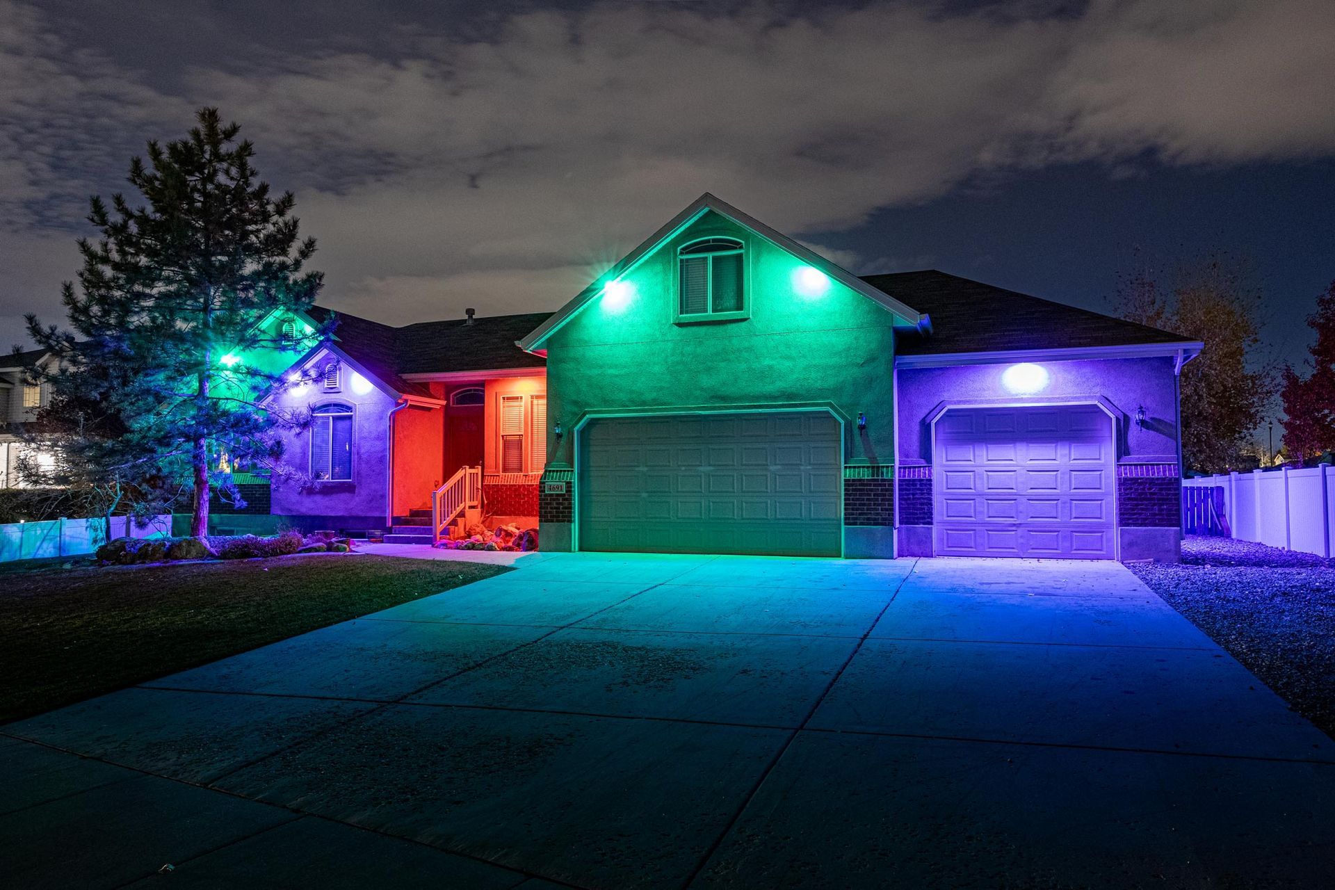 A house is lit up with colored lights at night.