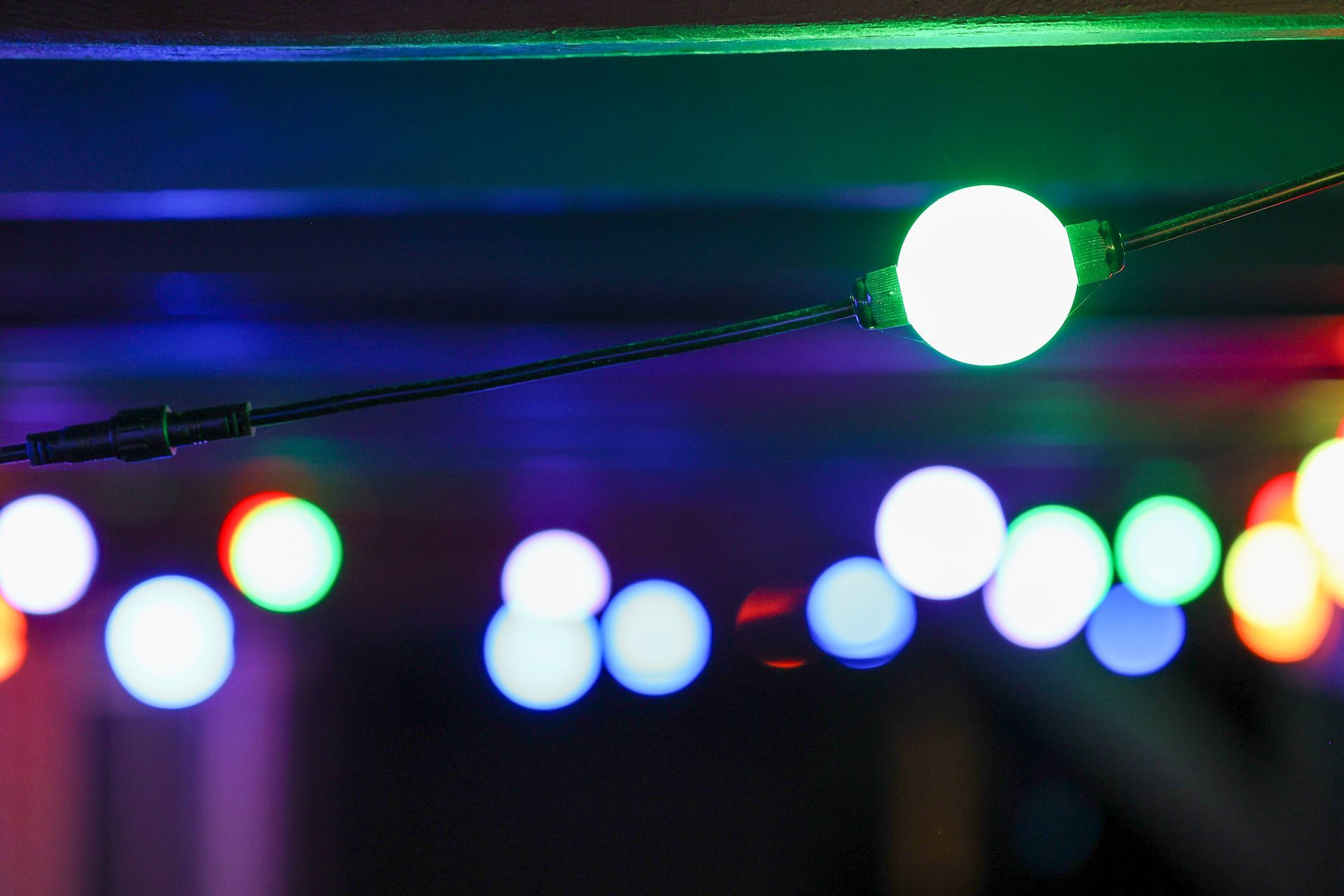 A string of colorful lights hanging from the ceiling.