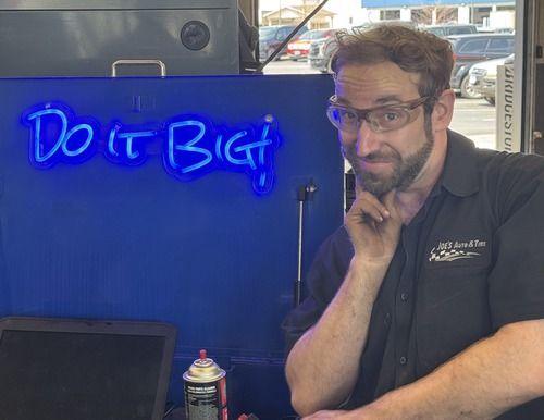 Man in glasses with hand on chin near 