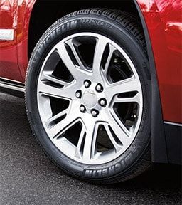 Silver car wheel with Michelin tire on a red vehicle. | Joe's Auto and Tire 