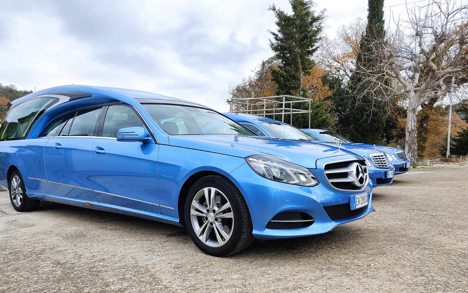 inquadratura laterale di carro funebre blu