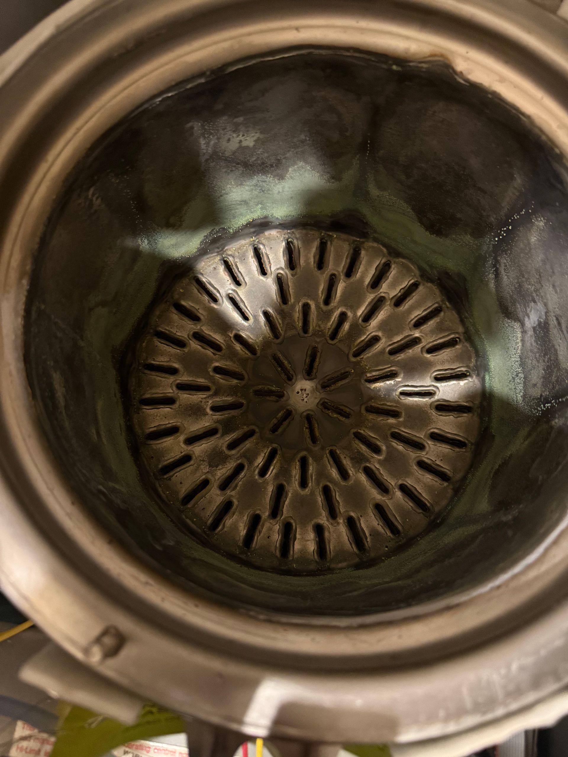 A close up of the inside of a pot with holes in it.