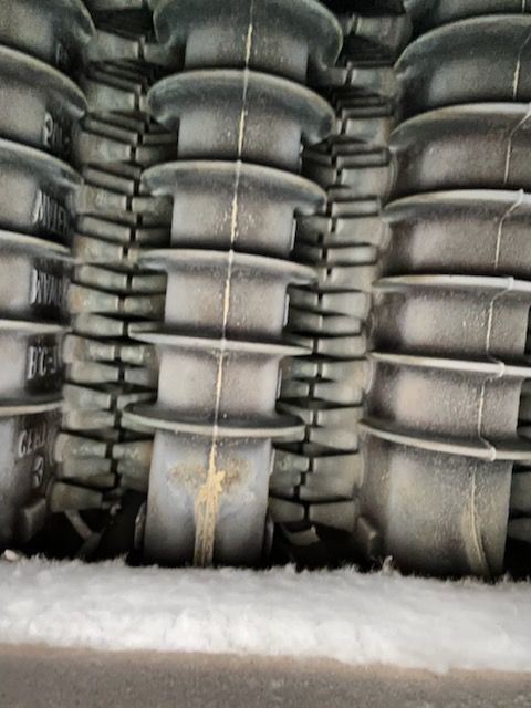 A stack of black containers with the letters bc on them