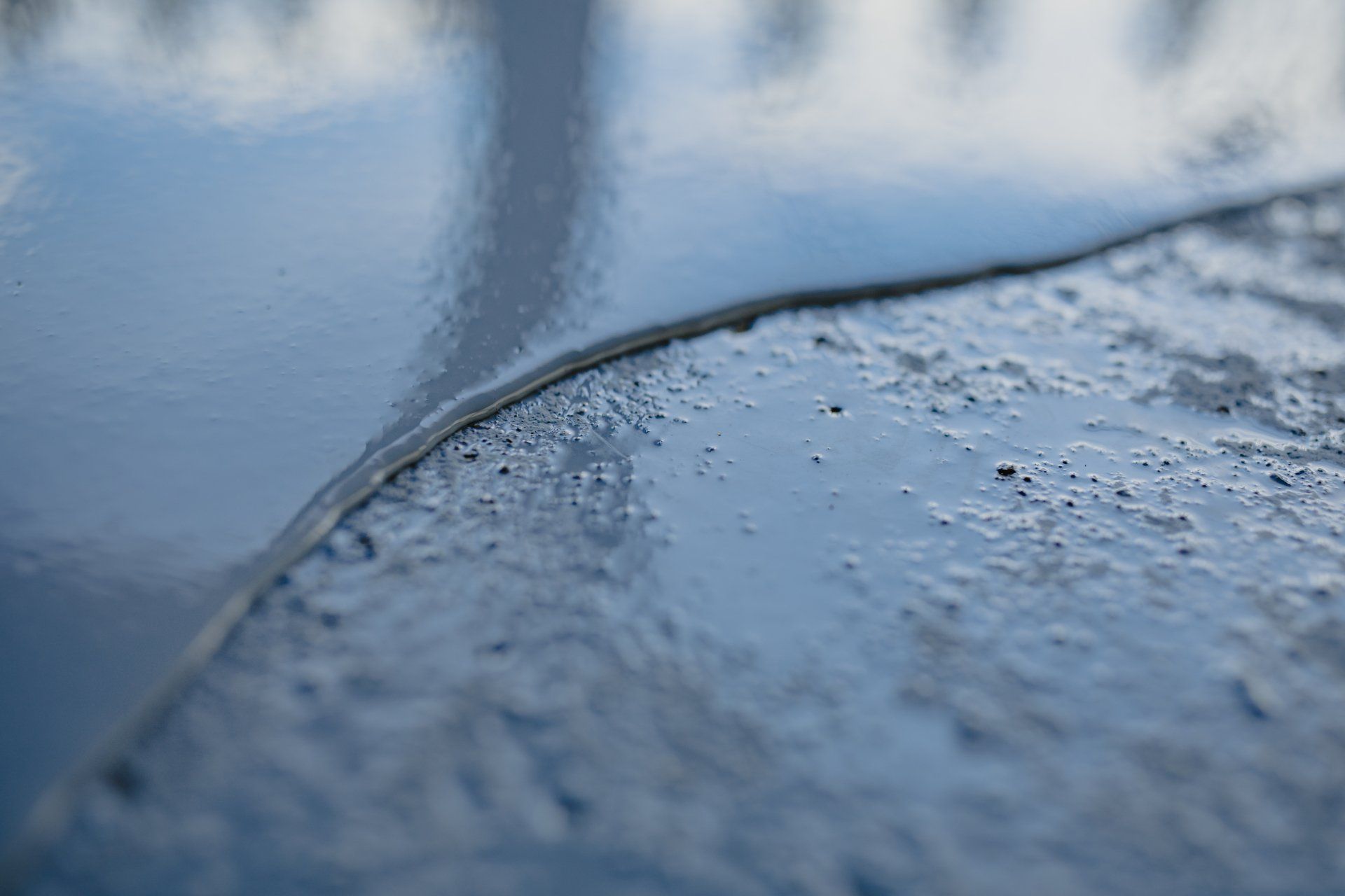 a close up of a concrete surface with a few drops of water on it .