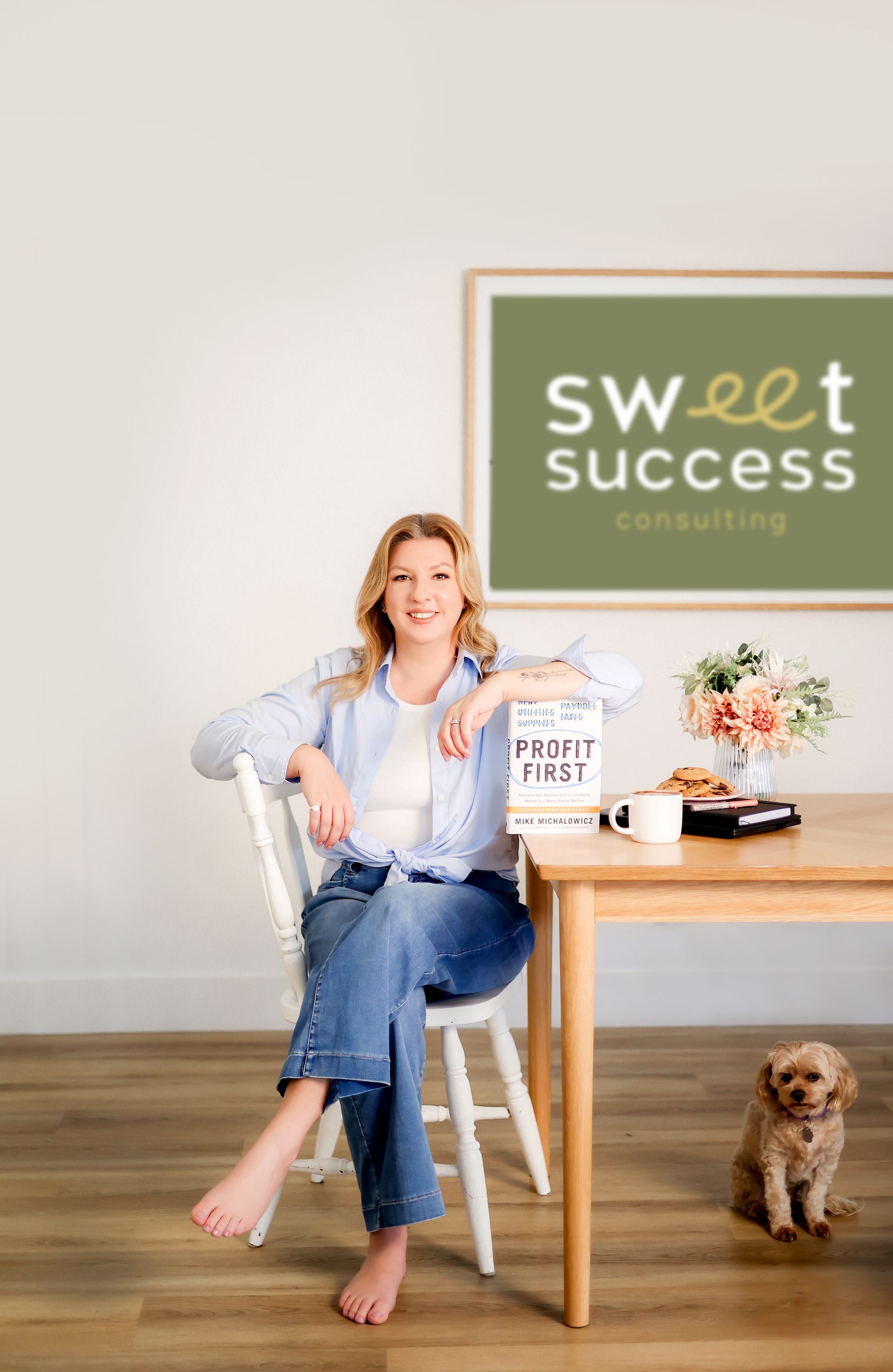Woman sitting, smiling, near a table with