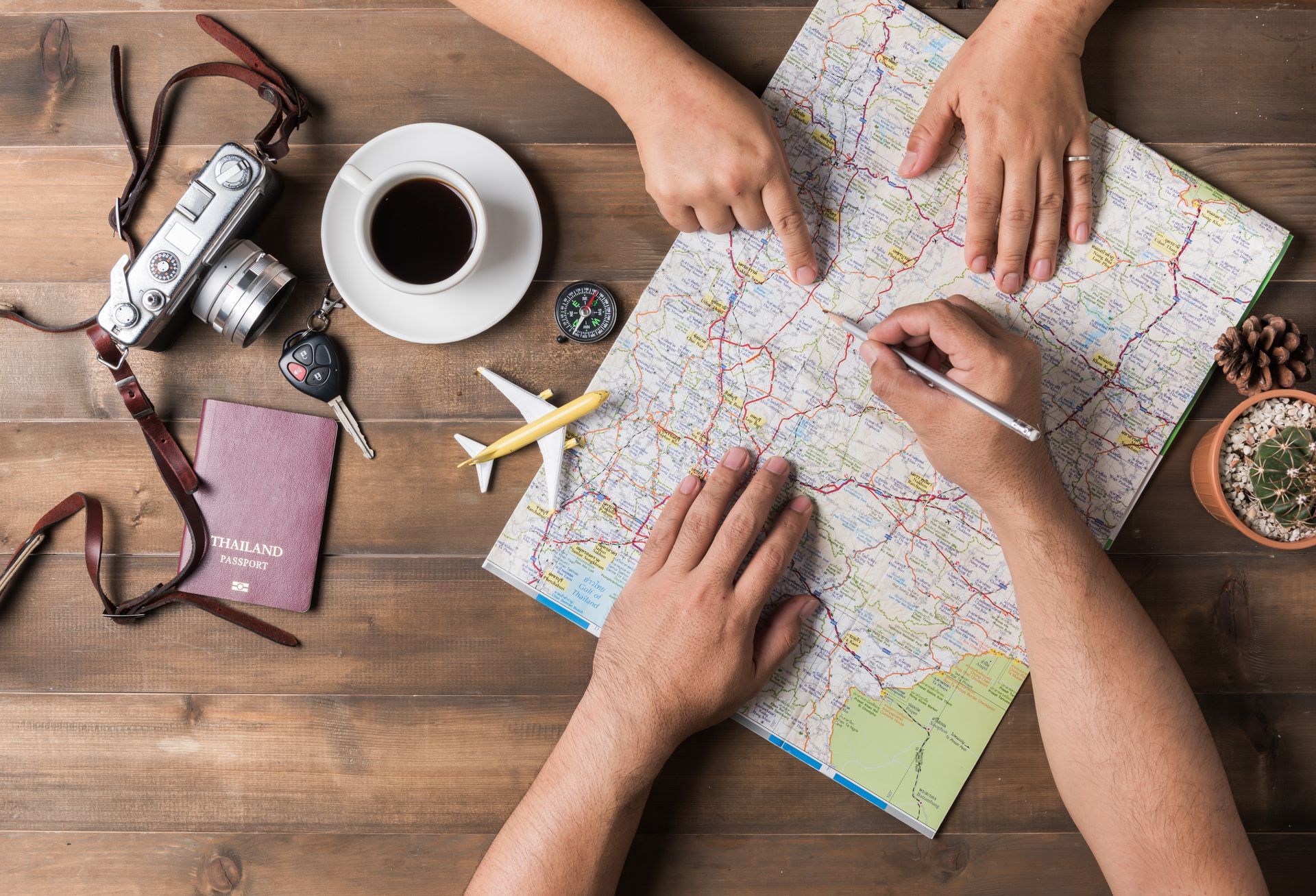 A man and a woman are sitting at a table looking at a map.