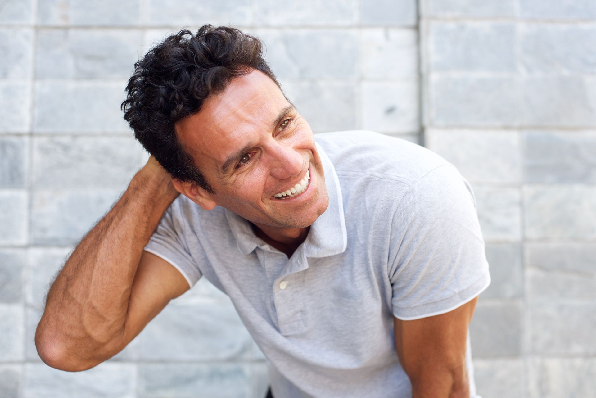 Smiling man representing non-surgical hair regeneration treatment candidate
