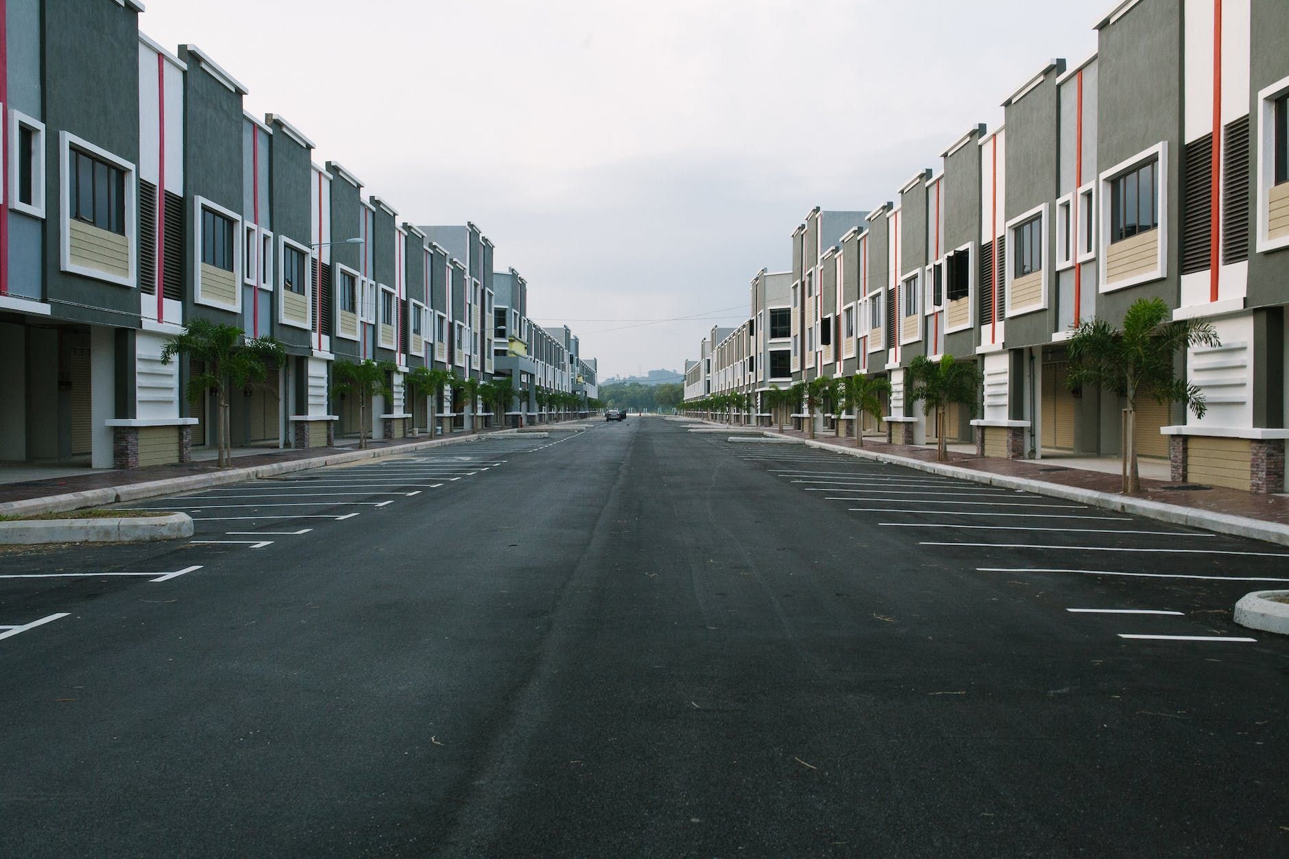 An empty street with a row of buildings on both sides