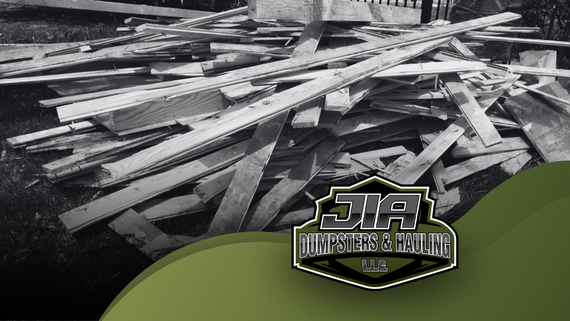 A black and white photo of a pile of wood with a dia logo in the corner
