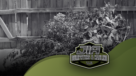 A black and white photo of a wooden fence with a green motorcycle in the foreground