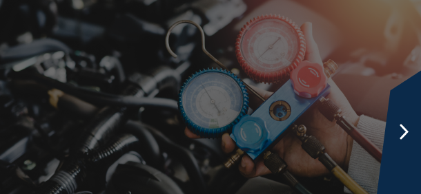 Interior view, likely of a machine or apparatus, with a dark surface and a blue navigation arrow on the  | Marshside Motors