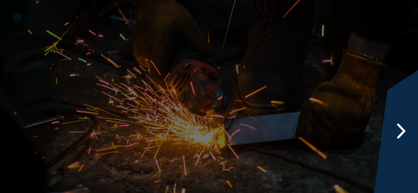 Close-up of truck tires in a garage setting with a dark blue sidebar and a right arrow | Marshside Motors