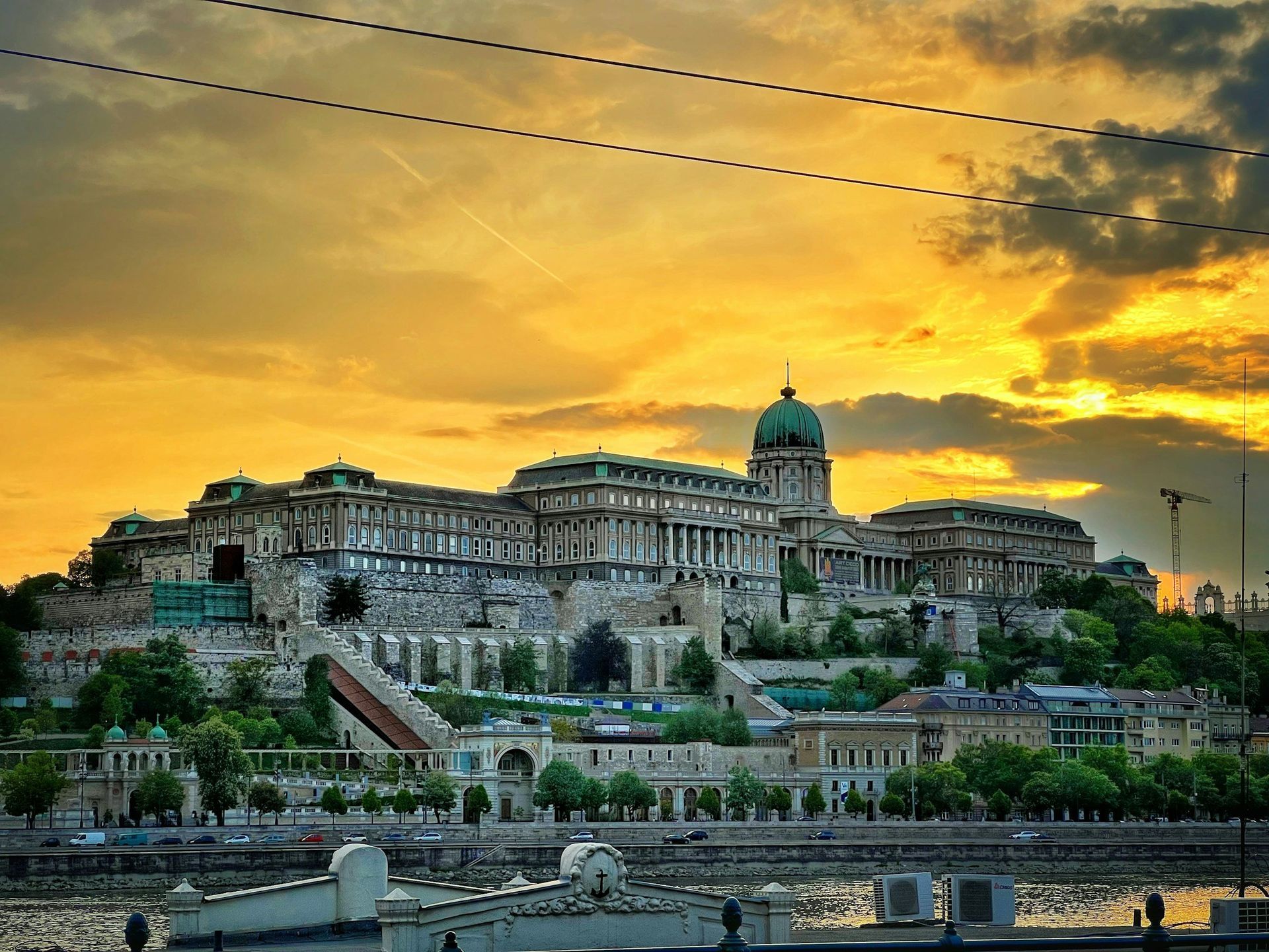 Budapest Castle against a sunset sky over the Danube River.