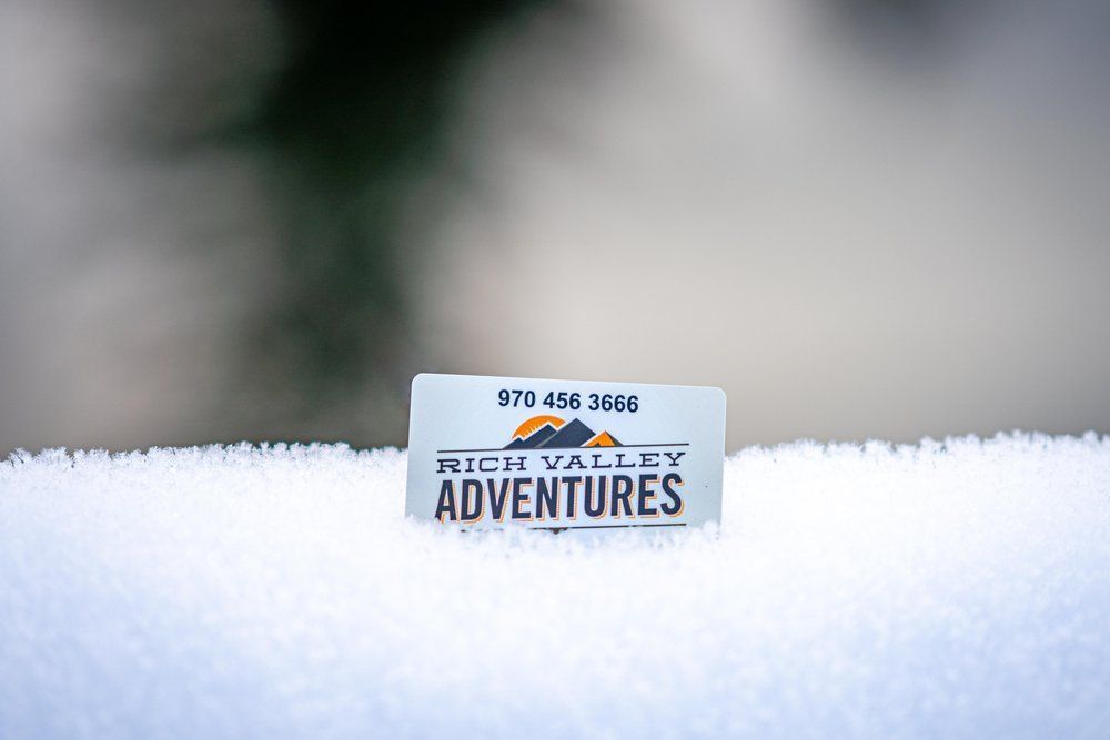 A white towel with a label that says rich valley adventures on it.