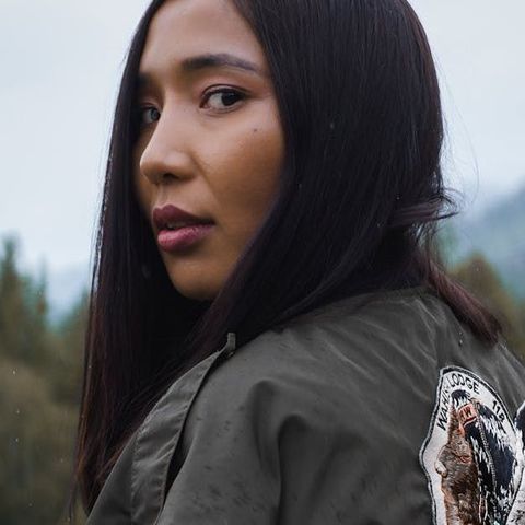 A close up of a woman wearing a green jacket