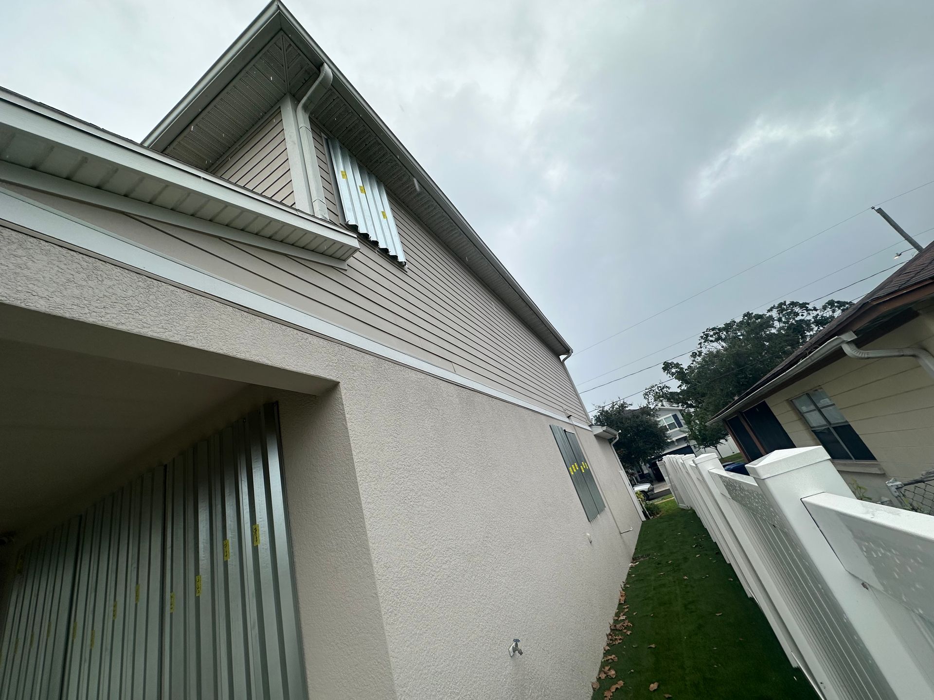 A white house with a white fence in front of it