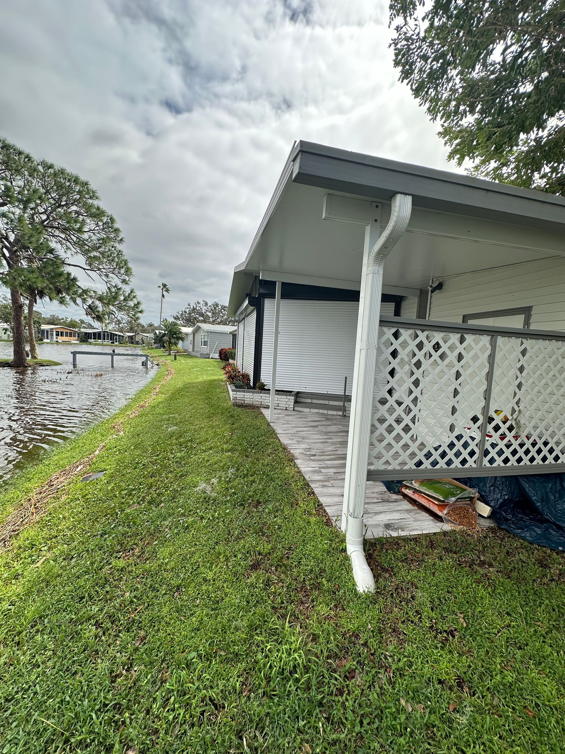A mobile home is sitting next to a body of water.