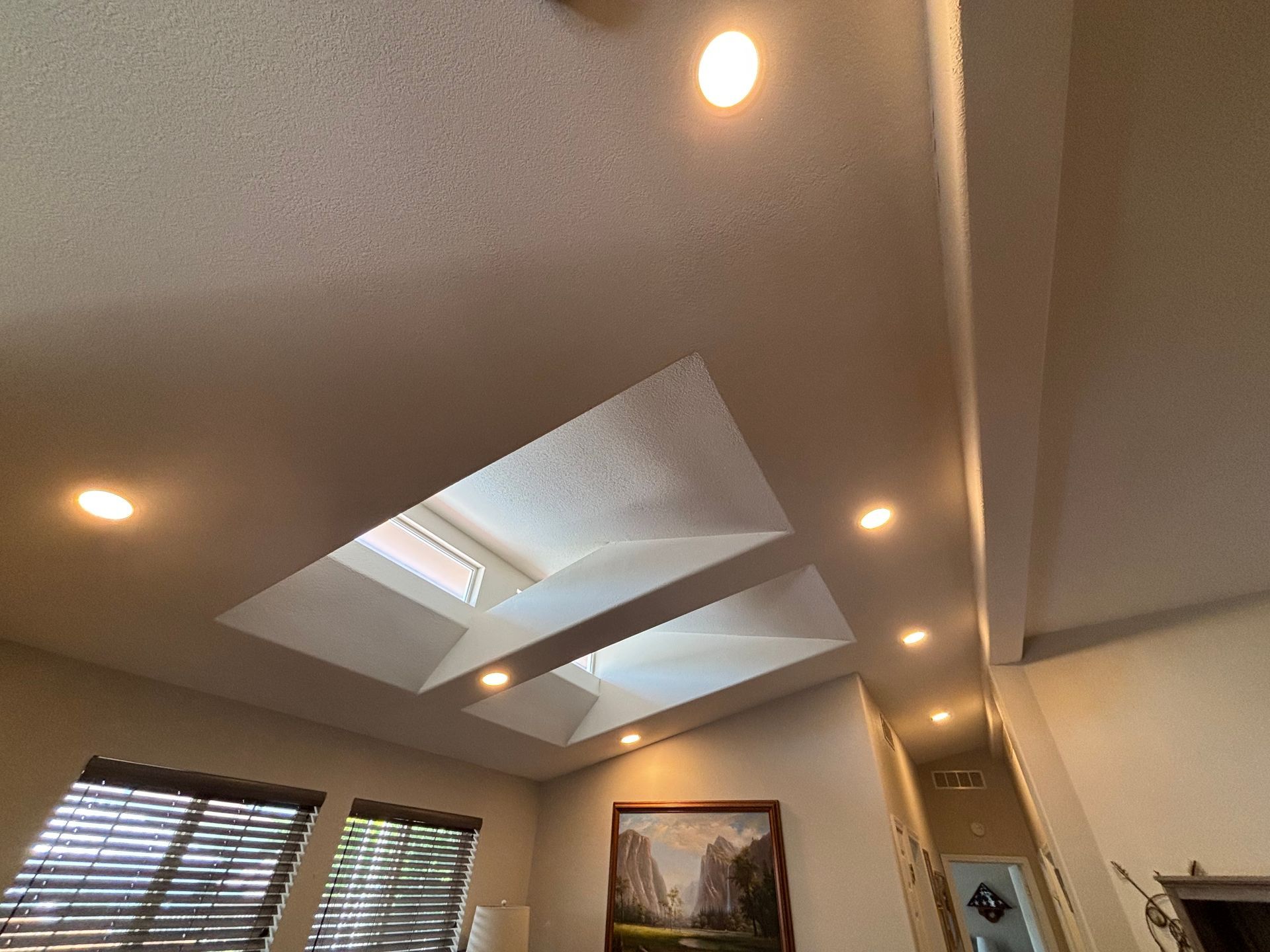 Interior view with a skylight and recessed lighting in a light-colored ceiling.