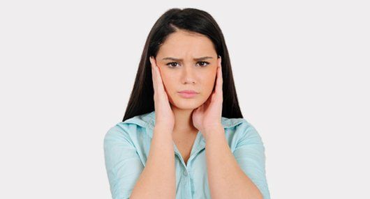woman closing her ears