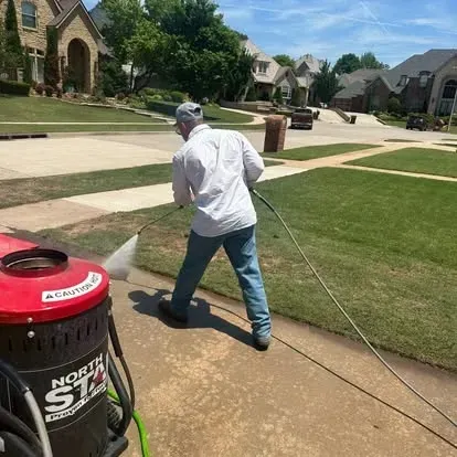 power washing driveway after freshly mowed lawn 