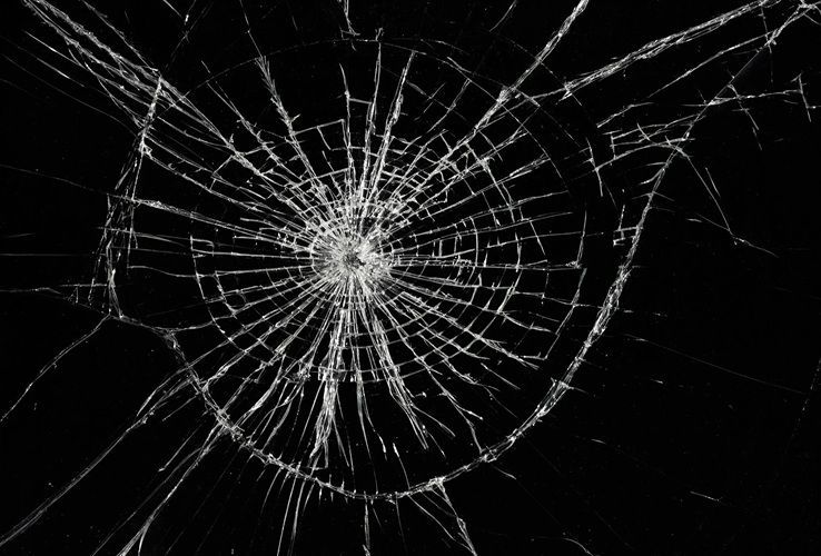 A close up of a broken glass on a black background