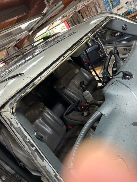 A car with a broken windshield in a garage