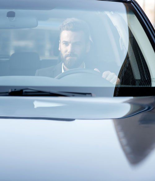 Auto Glass - Business Man Driving a Car in Seattle, WA