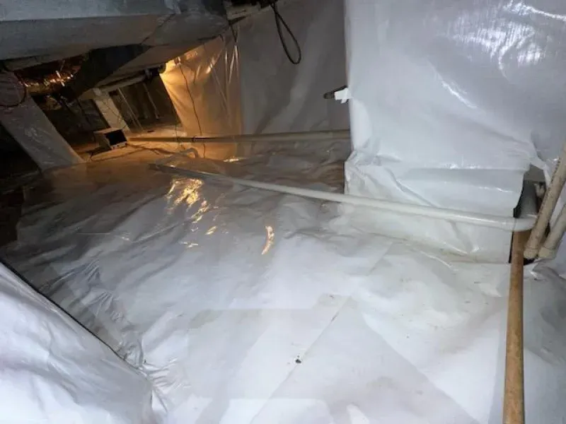 White crawl space with vapor barrier.