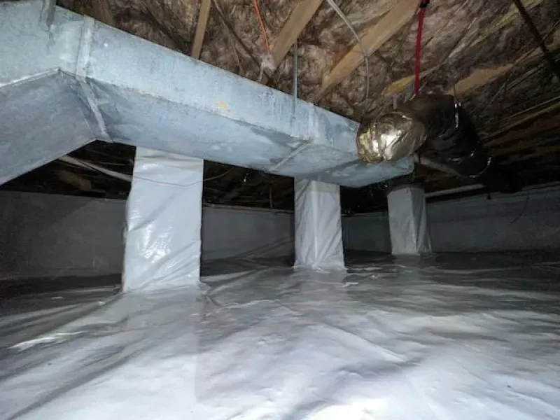 Crawl space with white vapor barrier on floor and columns. Ductwork and vent visible.