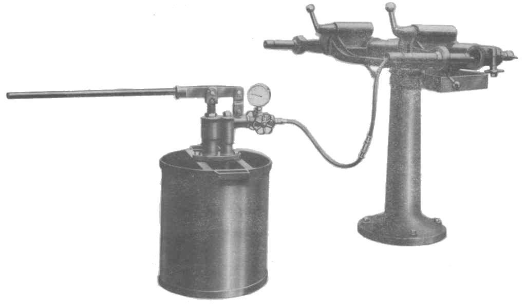 A black and white photo of a machine with a hose attached to it.