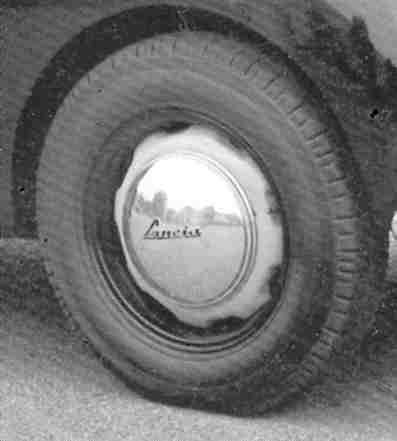 A black and white photo of a tire on a car.
