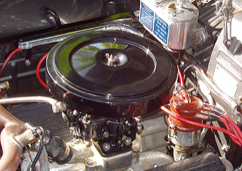 A close up of a car engine with red wires