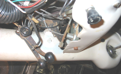 A close up of a steering wheel with wires coming out of it